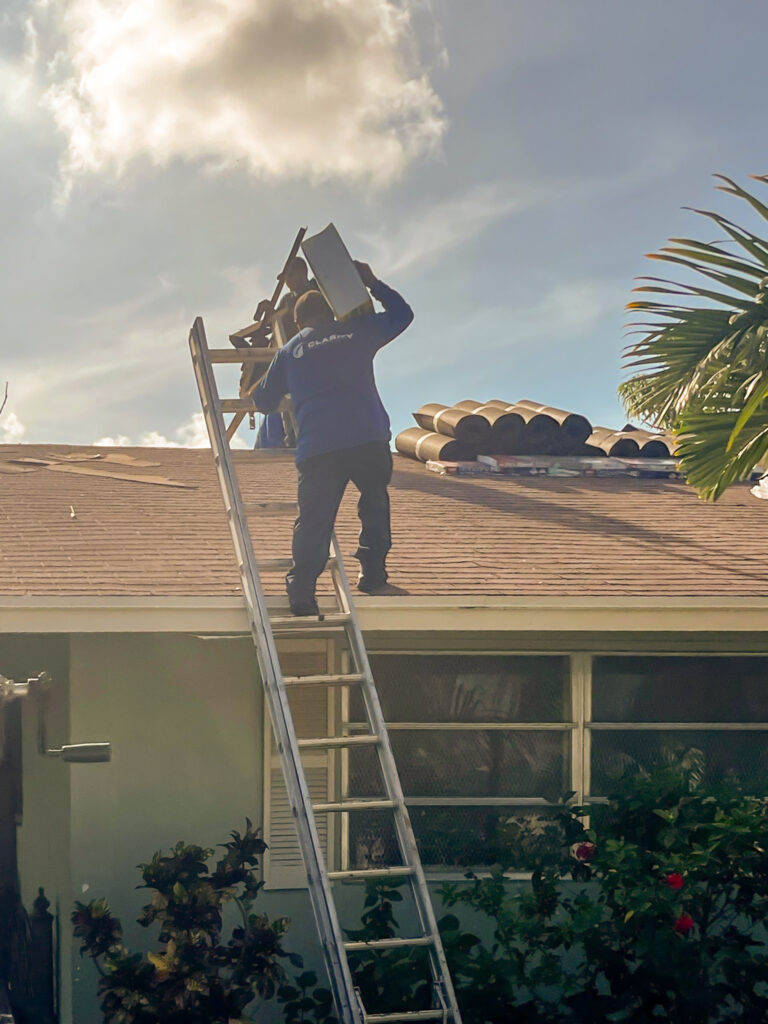 Clarity Roofing technician performing roof repair on a South Florida residential property