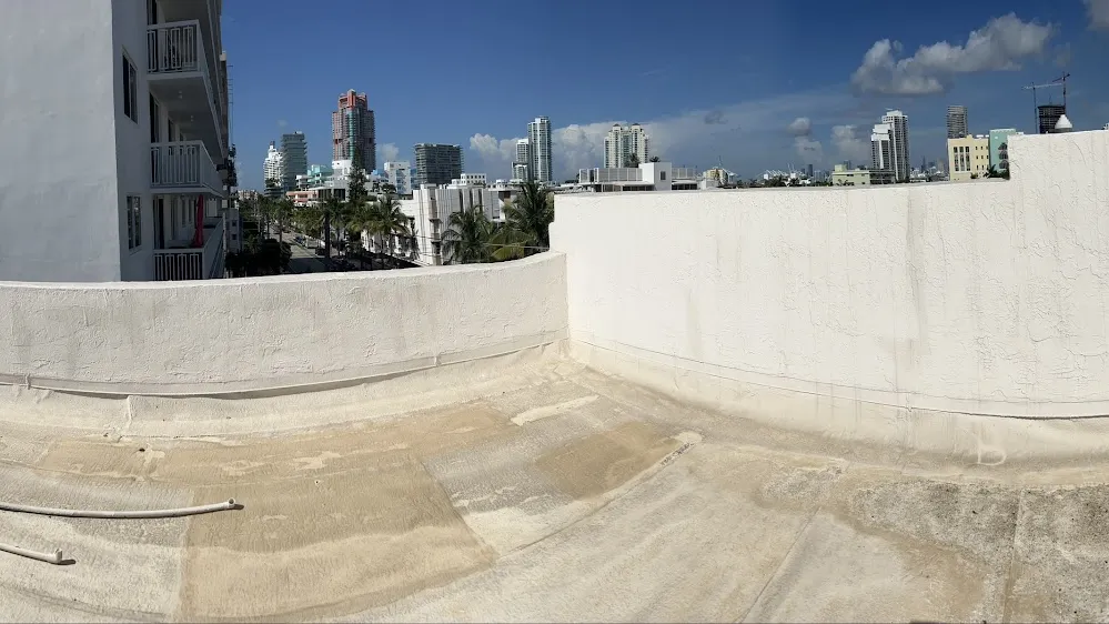 Coated commercial roof deck with city skyline in the background